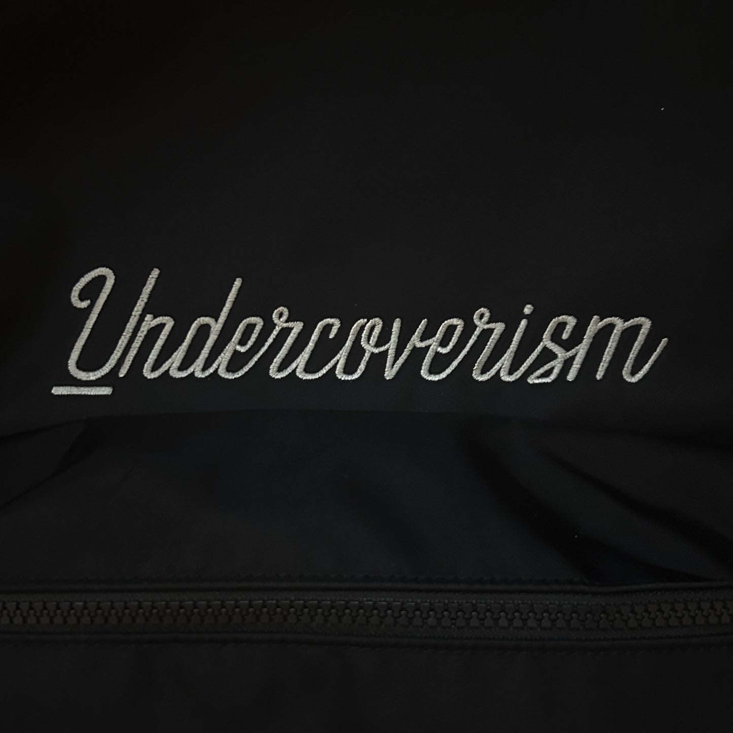 “UNDERCOVERISM” EMBROIDERED LOGO BACKPACK